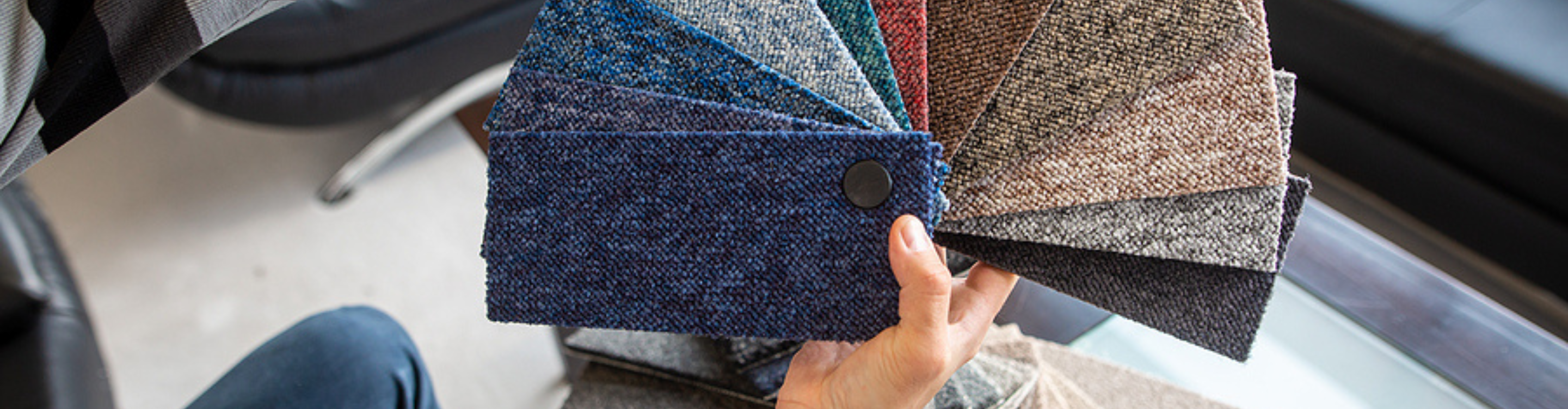 Colorful carpet samples with hands. 